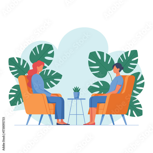 Two women in therapy session sitting in armchairs with tropical plants backdrop