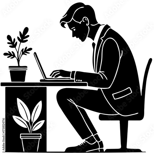 Office worker using laptop at desk with plants