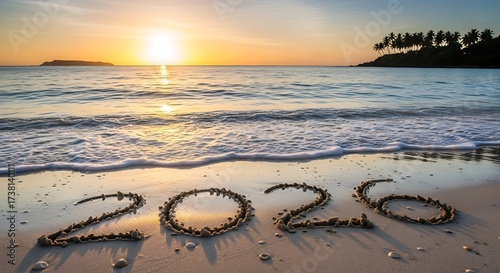 Fototapeta Naklejka Na Ścianę i Meble -  The year 2026 written in sand on a beach at sunset