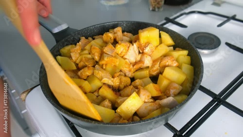 Chef woman hands stirring chicken and potatoes cooking in frying pan on kitchen. Culinary techniques, homemade preparing healthy meal cook meat vegetables food, organic cuisine from fresh ingredients.