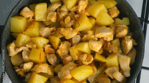 Cooked fried chicken and potatoes cooking in frying pan on kitchen. Culinary techniques, homemade preparing healthy meal cook meat vegetables food, organic cuisine from fresh ingredients.