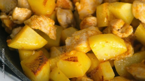 Cooked fried chicken and potatoes cooking in frying pan on kitchen. Culinary techniques, homemade preparing healthy meal cook meat vegetables food, organic cuisine from fresh ingredients.