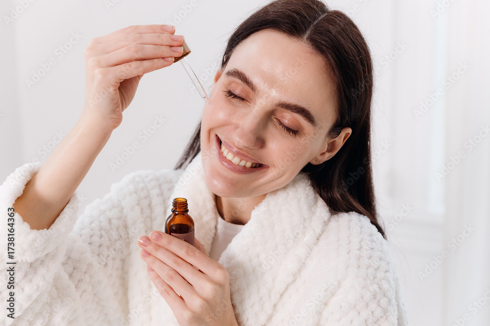 Fototapeta premium Woman enjoying a skincare routine in a modern bathroom for morning pampering