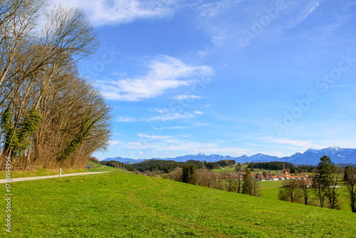Road near Böbing in the district of Weilheim-Schongau in Bavaria on a sunny spring day with a blue sky