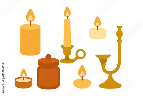 Assortment of glowing wax candles and ornate metallic candle holders for decoration