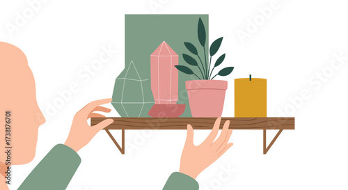 Person arranging decorative items on a shelf.