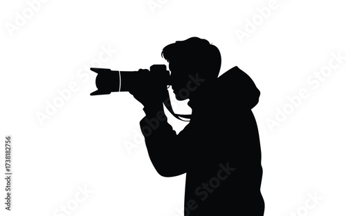 Silhouette of a photographer holding a professional camera capturing a moment