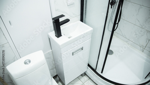 Konstfotografi Black modern shower enclosure with small vanity and stylish black faucet in the