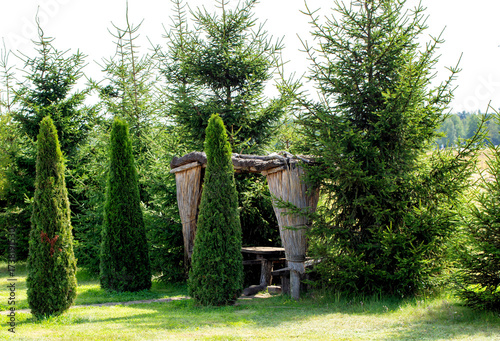 Wallpaper Mural A beautiful gazebo made of dry reeds against a backdrop of fir trees and thujas at a dacha, landscape design Torontodigital.ca