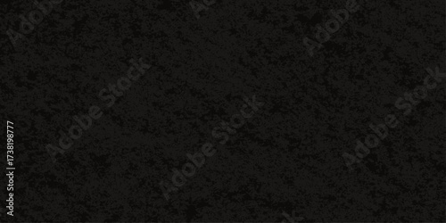 Rough black asphalt texture with a dark and grey distressed surface pattern for a grunge background design