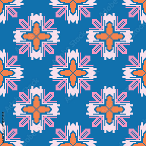 Pixel art textile pattern with orange cross-shaped flowers, pink geometric details, and blue background, arranged in symmetrical repetition.