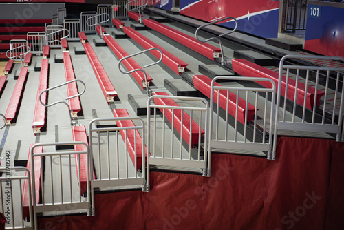 Red cushioned bleacher seats with gray safety rails, visible section signage. Team banners, seating gaps highlight thoughtful stadium planning, inclusive college design features in Dallas, Texas