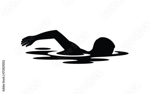 Silhouette of a person swimming powerfully through calm water