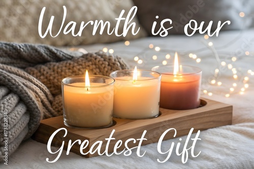 Burning candles in glass holders on wooden tray for cozy warmth