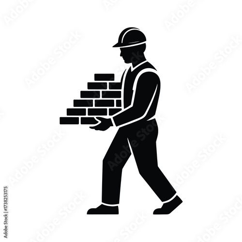 Silhouette of a construction worker carrying a stack of bricks