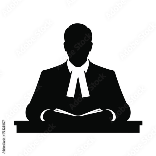 Silhouette of a judge or lawyer sitting at a desk reading a book