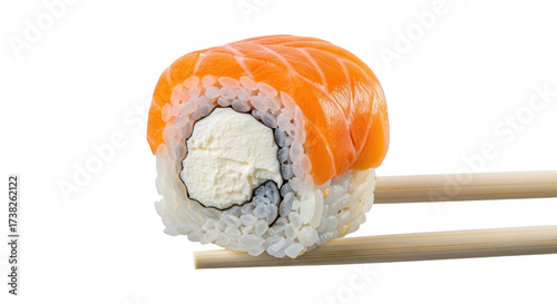 Isolated Philadelphia sushi roll with salmon on chopsticks ready to eat food cuisine