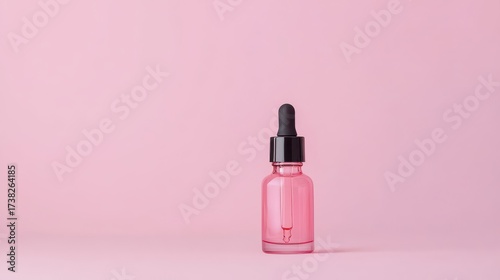 Wallpaper Mural A pink dropper bottle stands against a soft pink background, creating a minimalistic and elegant aesthetic ideal for beauty or skincare products. Torontodigital.ca