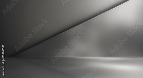 Empty gray room with a diagonal light source casting shadows.