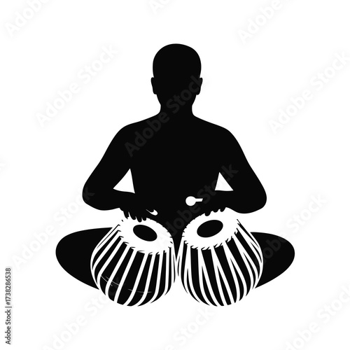 Silhouette of a musician playing the tabla musical instrument