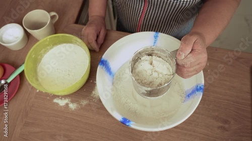 Wallpaper Mural Sifting flour through sieve into bowl. Unrecognizable person sieving powder into dish. Straining ingredient into container. Preparing dough for homemade bread Torontodigital.ca