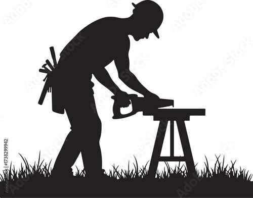 Silhouette carpenter sawing wood on sawhorse in grass