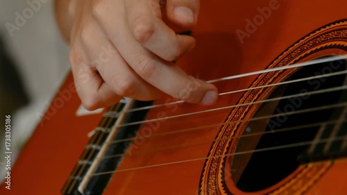 Child with motor disablilities while doing guitar practice lessons at home, music therapy, 4k