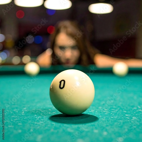 Woman aiming at cue ball on pool table
