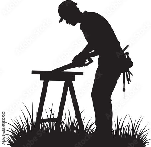 Silhouette of a man sawing wood on a sawhorse outdoors