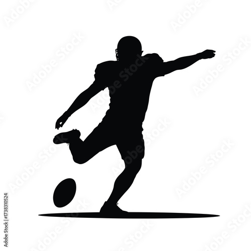 Silhouette of an american football player kicking a ball