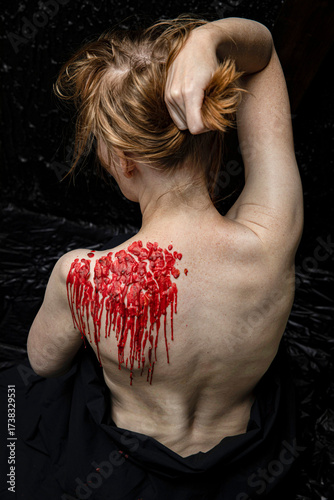 Canvastavla Red wax on back of young submissive woman. Close up.