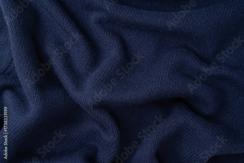 Navy blue merino wool sweater texture as background. Top view.