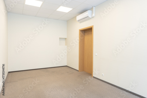 Minimalist Interior of an Empty Room With Beige Walls and Wooden Door. 