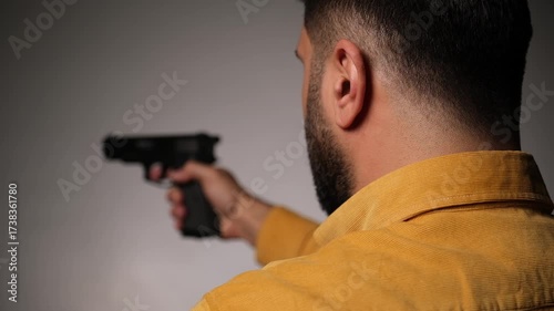 Man Pointing a Handgun at Another Person — Staged Studio Shot