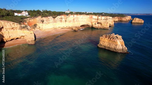  Amazing Algarve coast. Summer destination in Portugal. Best scenic becahes - Breathtaking  rocks of Praia da Marinha. Aerial drone 4k hd video.
