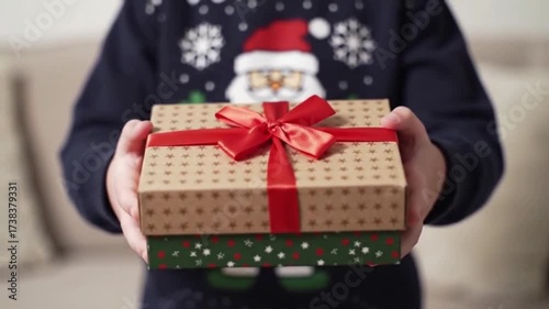 child with a Christmas present in his hands