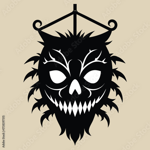 Fierce black silhouette of a spiky monster face hanging from a frame
