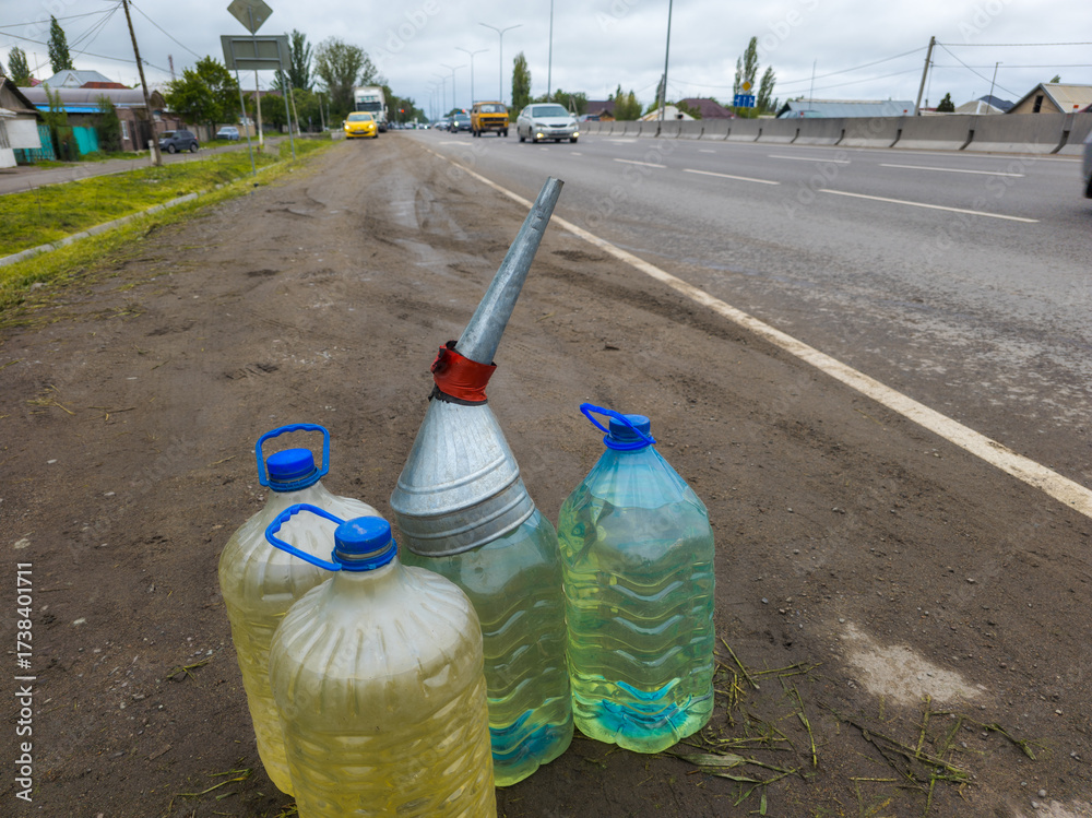 Φωτογραφία cars passing by plastic bottles with gasoline on the side of the road, street ga