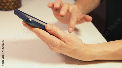 Closeup hands video of business woman holding in hands mobile phone and working, texting, chatting in office.  Businesswoman job concept