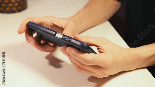 Closeup hands video of business woman holding in hands mobile phone in horizontal position and working, texting, chatting in office.  Businesswoman job concept