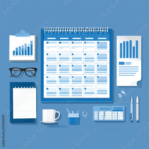 Workspace with calendar planning charts and various stationery items on a blue background creating a productive atmosphere