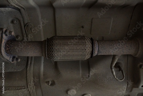 A muffler corrugation with a burnt seam in the exhaust system of a passenger car