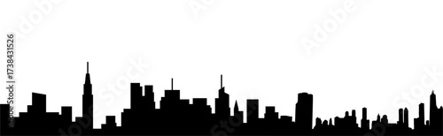 Dramatic silhouette of urban cityscape against bright sky highlighting architectural detail