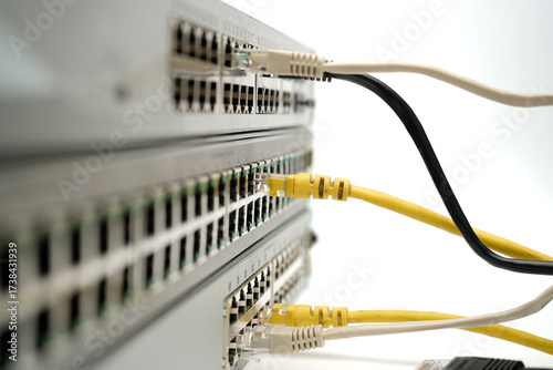 Obraz na płótnie Close-up of network switch ports with connected Ethernet cables, representing data transfer, internet connectivity and modern digital infrastructure in a technical environment