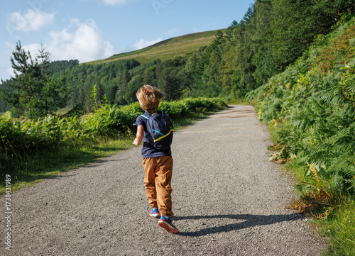 Happy child explores a vibrant landscape under the sun