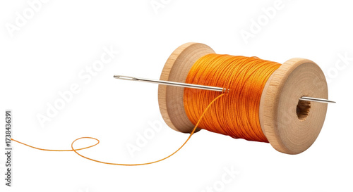 Isolated sewing needle going through a wooden spool with thread or string, a needlework tool