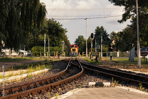 Obraz na plátně Train on rural railway tracks at level crossing