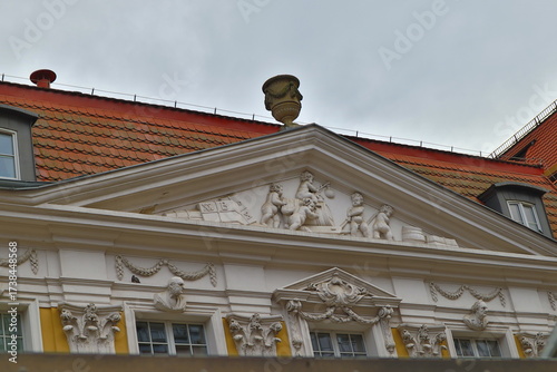a building with a sculpture on a cloudy day