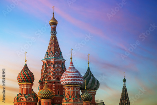 Cathedral in Moscow at sunset, with colorful onion domes and golden crosses against beautiful colorful bright sky. An iconic landmark and architectural masterpiece