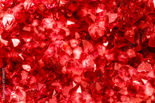Amethyst red crystals. Gems. Mineral crystals in the natural environment. Texture of precious and semiprecious stones. Seamless background with copy space colored shiny surface of precious stones.